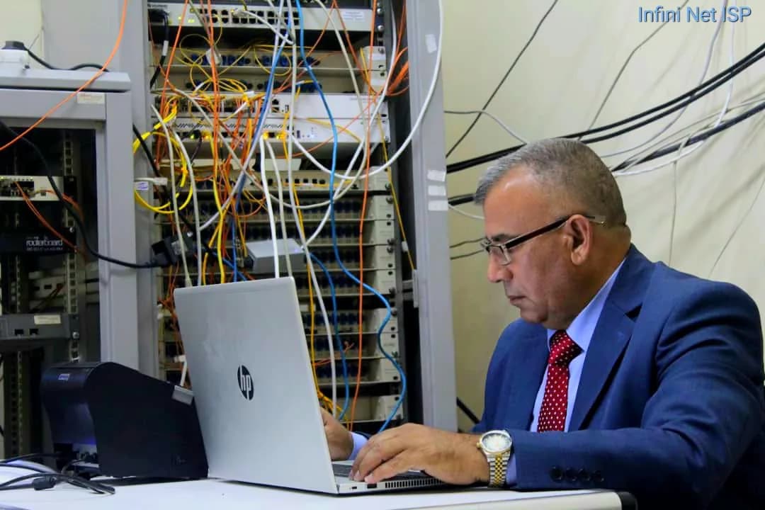 An Infini Net engineer working on a network cabinet